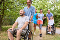 People enjoying a day at the park, with individuals using wheelchairs