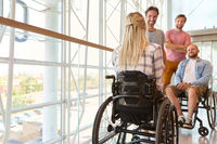 Paraplegic individuals and their friends enjoying time together indoors