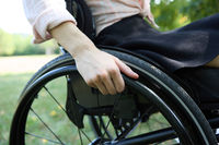 Close-up of a person using a wheelchair, focusing on independence and mobility