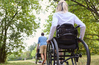 People using wheelchairs enjoying a peaceful day in a park setting