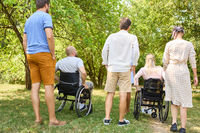 Inclusive friends enjoying a day at the park with people using wheelchairs